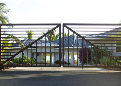 Metal residential double gate with striped pattern.