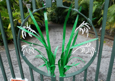 Detailed metal fabrication of rice plant on a metal gate in green