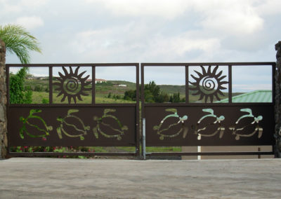 Large double gate with turtle and sun designs.